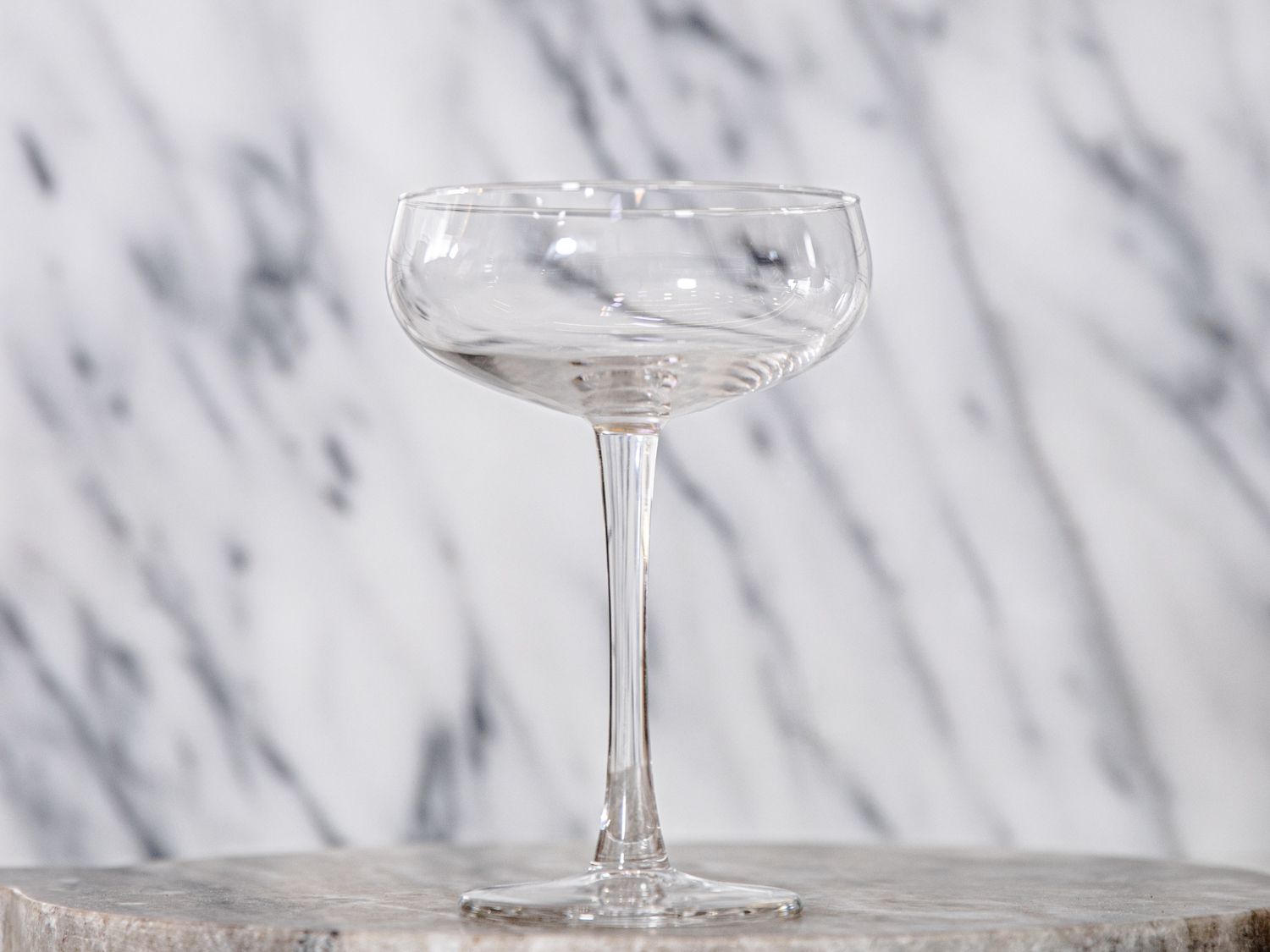 the IKEA coupe glass against a grey and white background