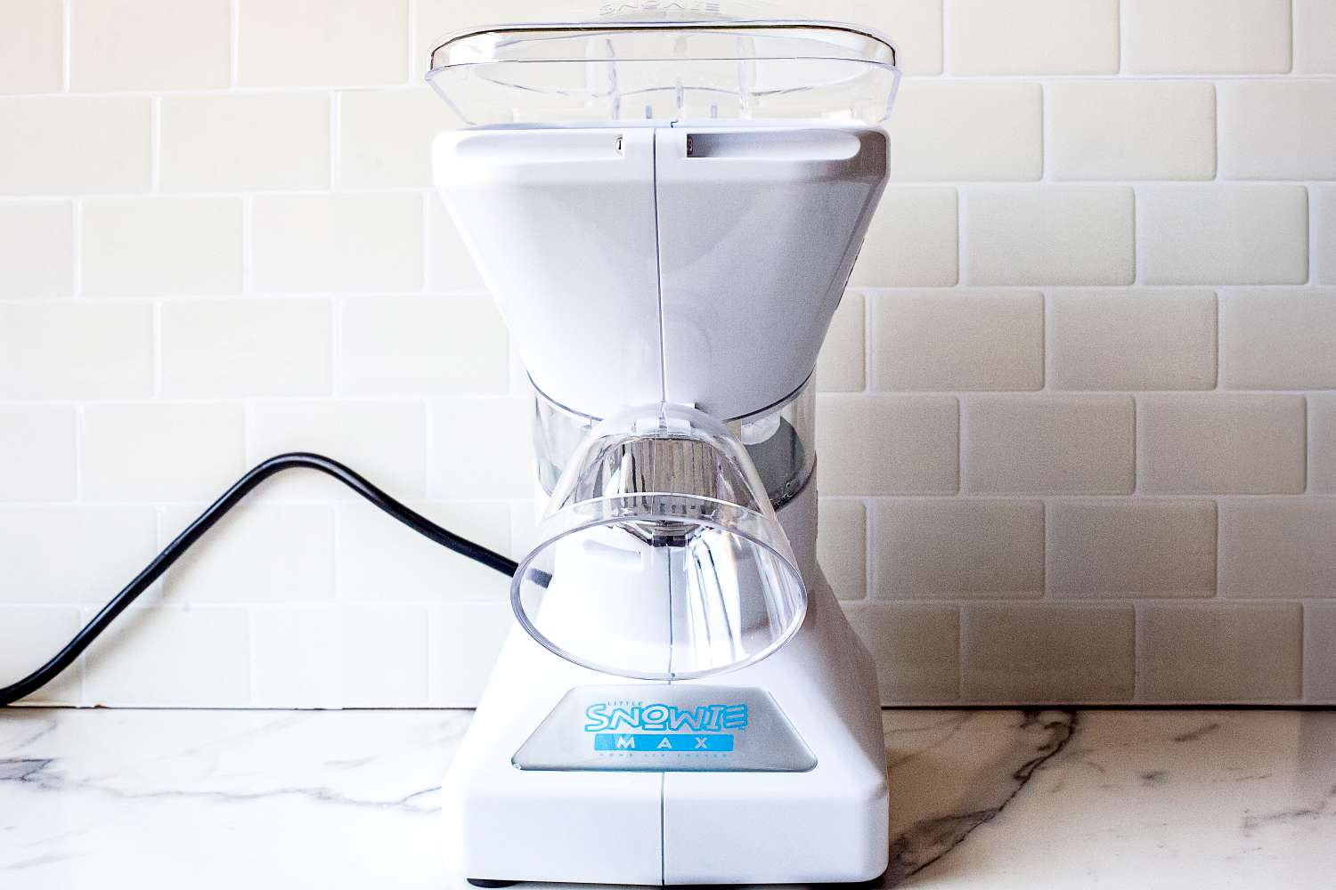 Snowie Little Snowie Max Snow Cone Machine on a kitchen counter