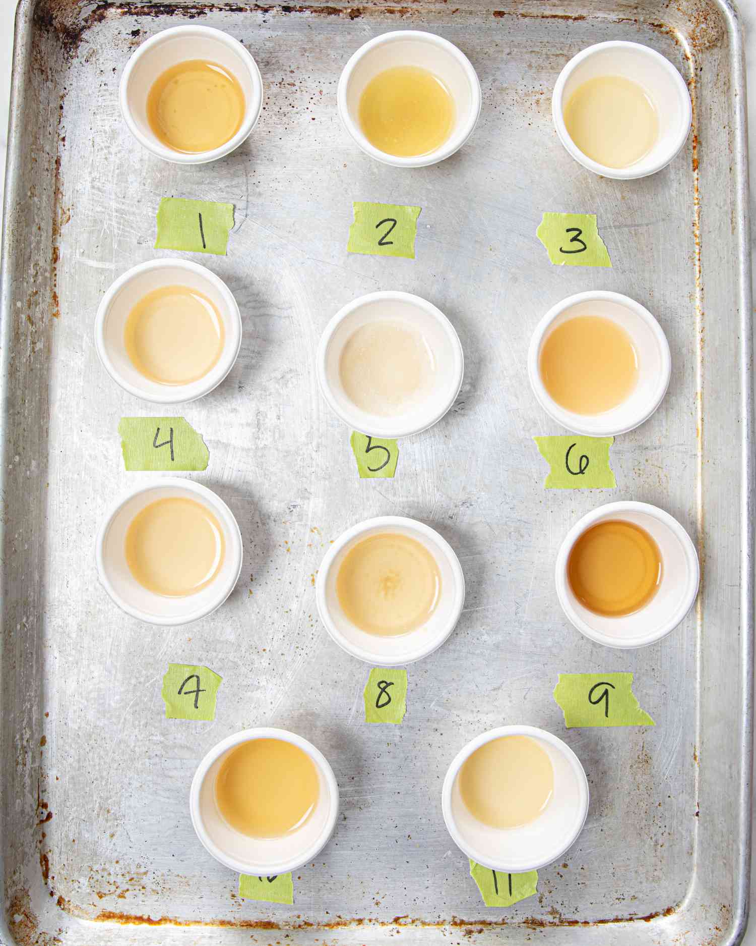 Overhead view of labeled chicken broth in tiny cups