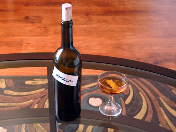 A bottle of homemade Italian-style amaro next to a cocktail