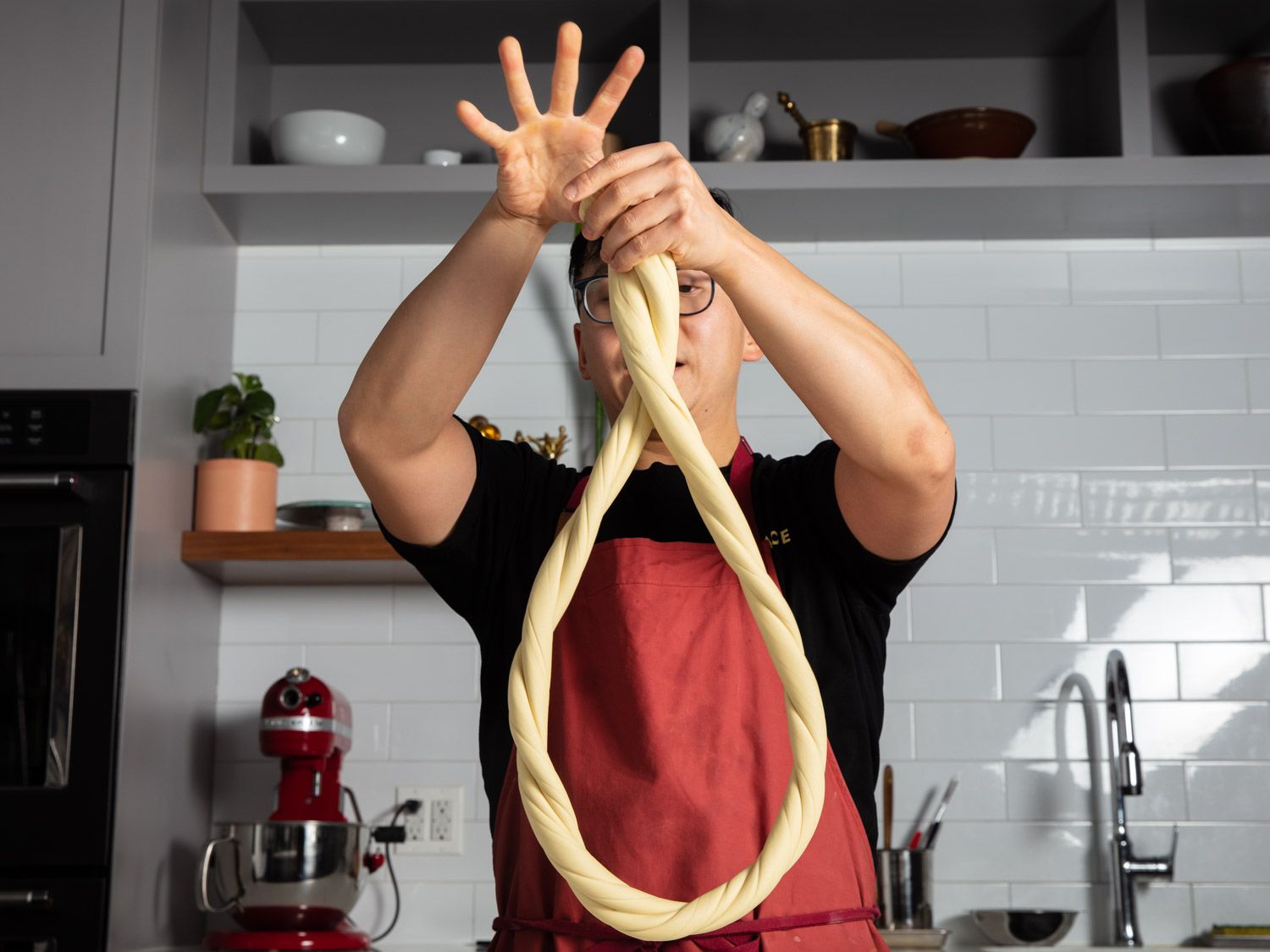 Twirling a rope of noodle dough for hand-pulled noodles.