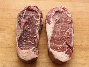 Two steaks side by side, one dry-aged and the other fresh.