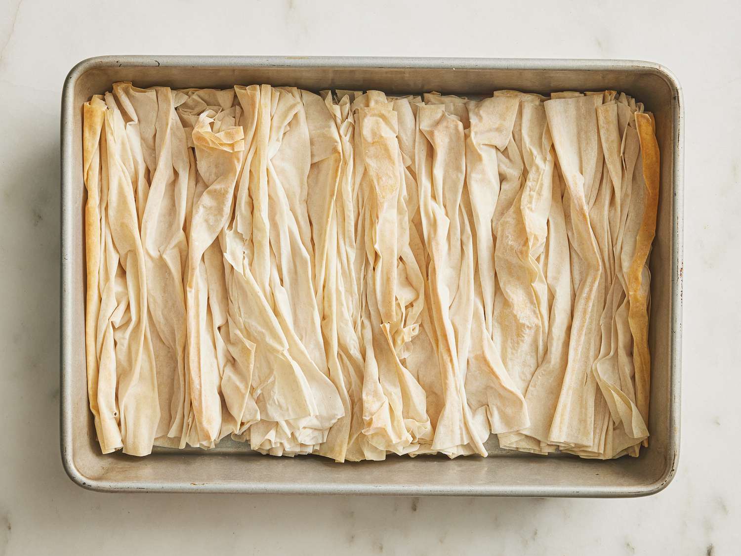 Crinkled phyllo sheets on a baking sheet 