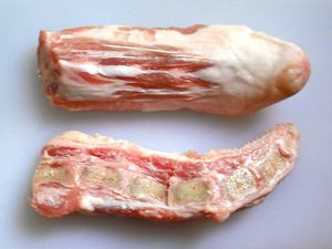A raw pig's tail sliced in half to reveal its cross-section. 