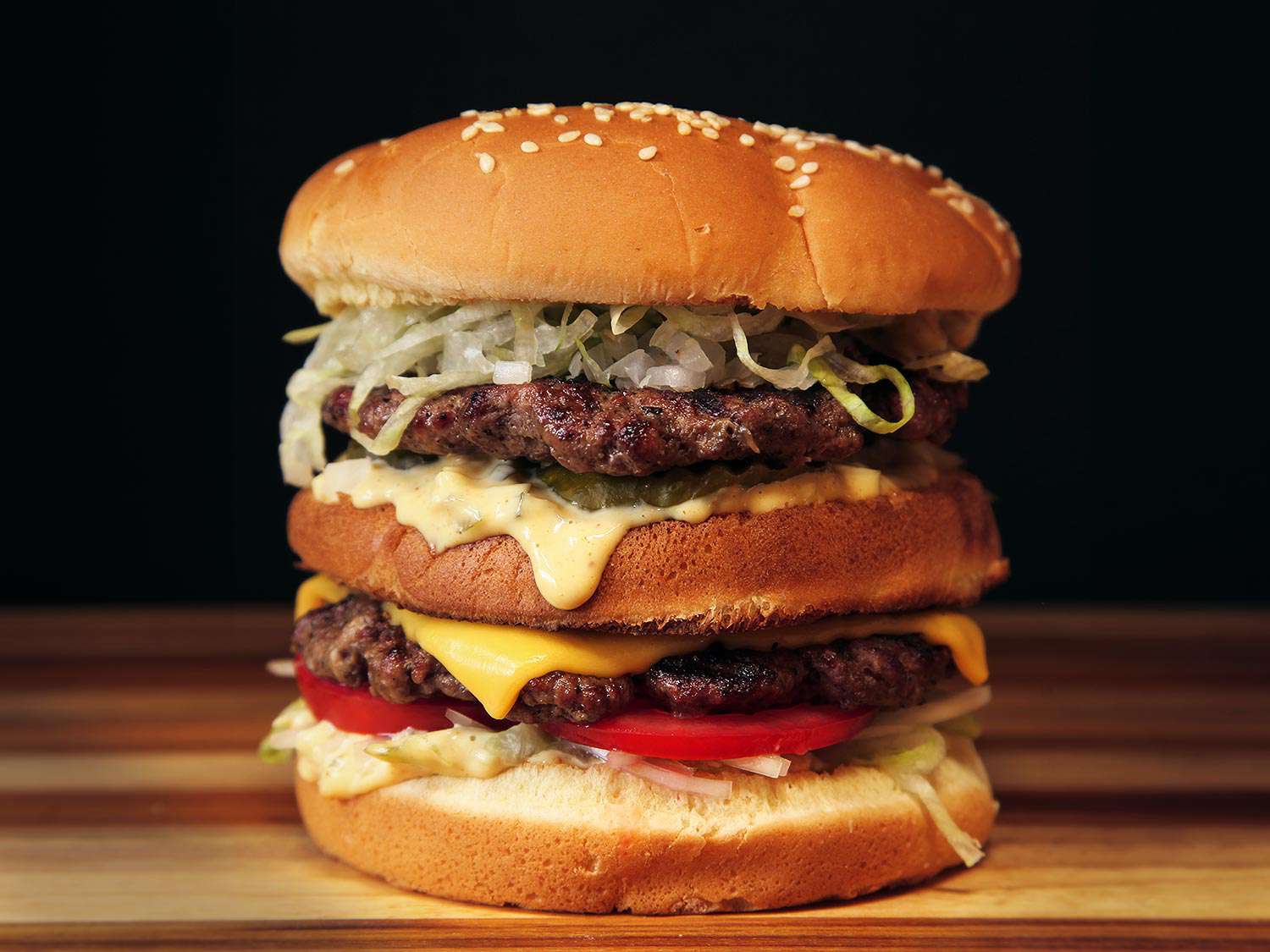 Profile view of a moodily-lit double-decker "McWhopper" burger.
