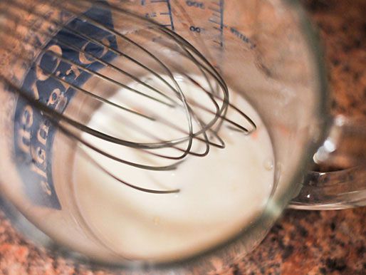 Whisking water and cornstarch in a measuring cup. 