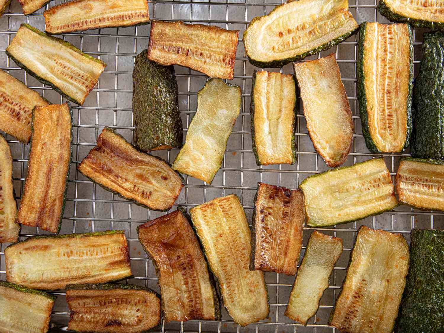 Slices of cooked zucchini resting on a cooling rack