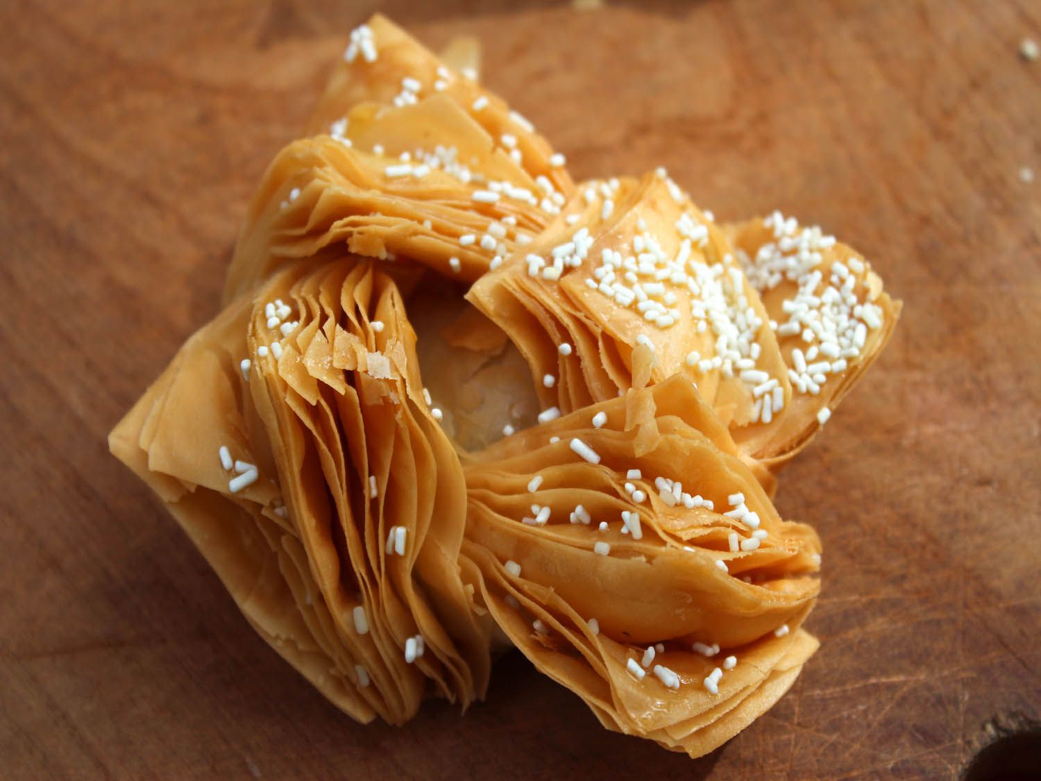 An Argentinian pastelitos, with white sprinkles scattered on top.