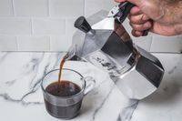 A person pouring coffee from the Bialetti Moka Espress