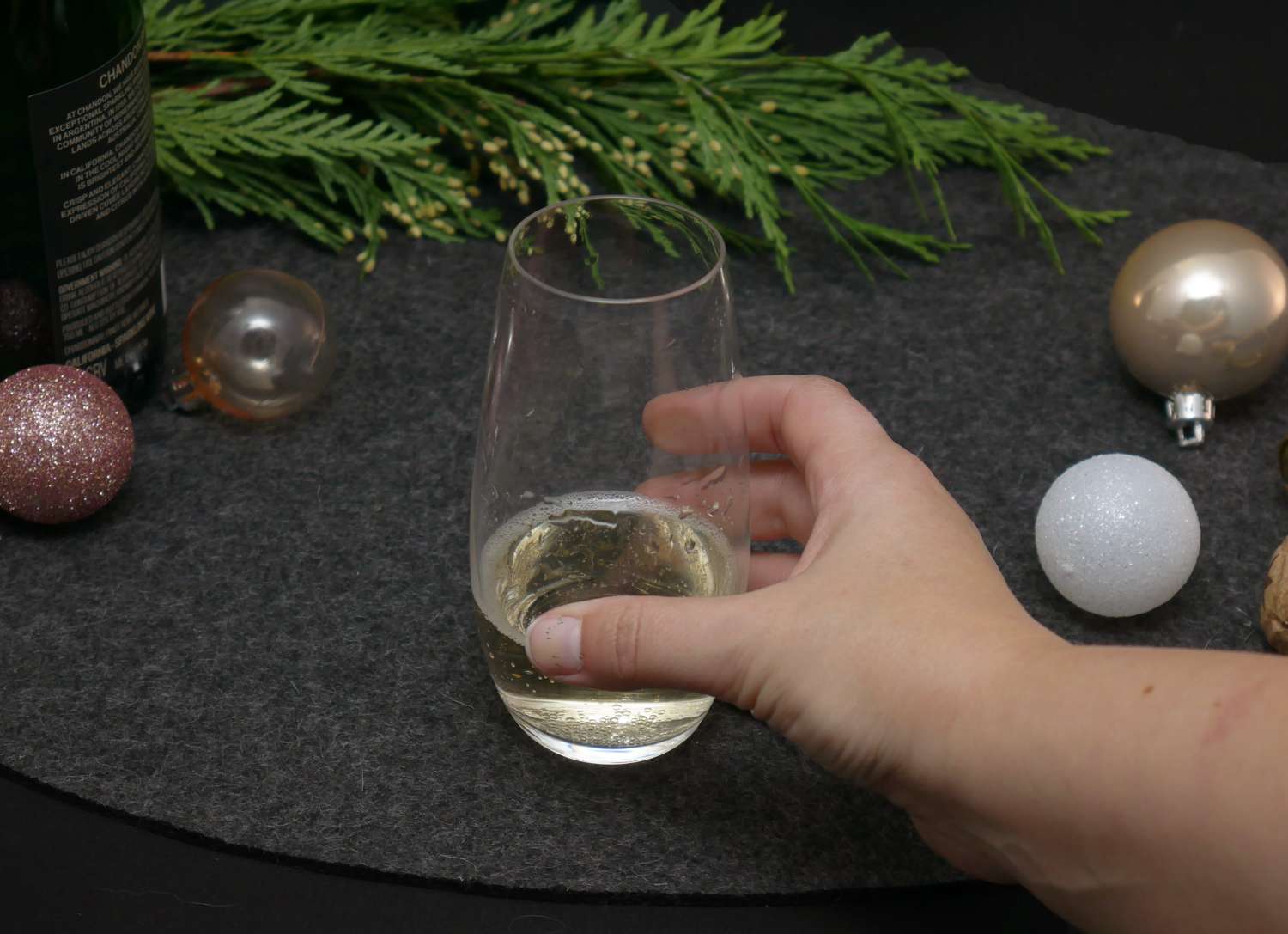 a person holding the riedel tumbler glass