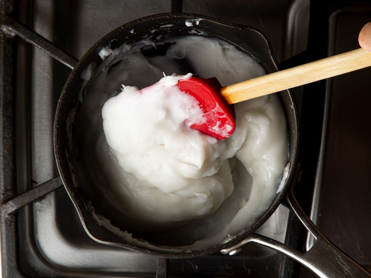 Overhead view of rice batter in a pot on a stove