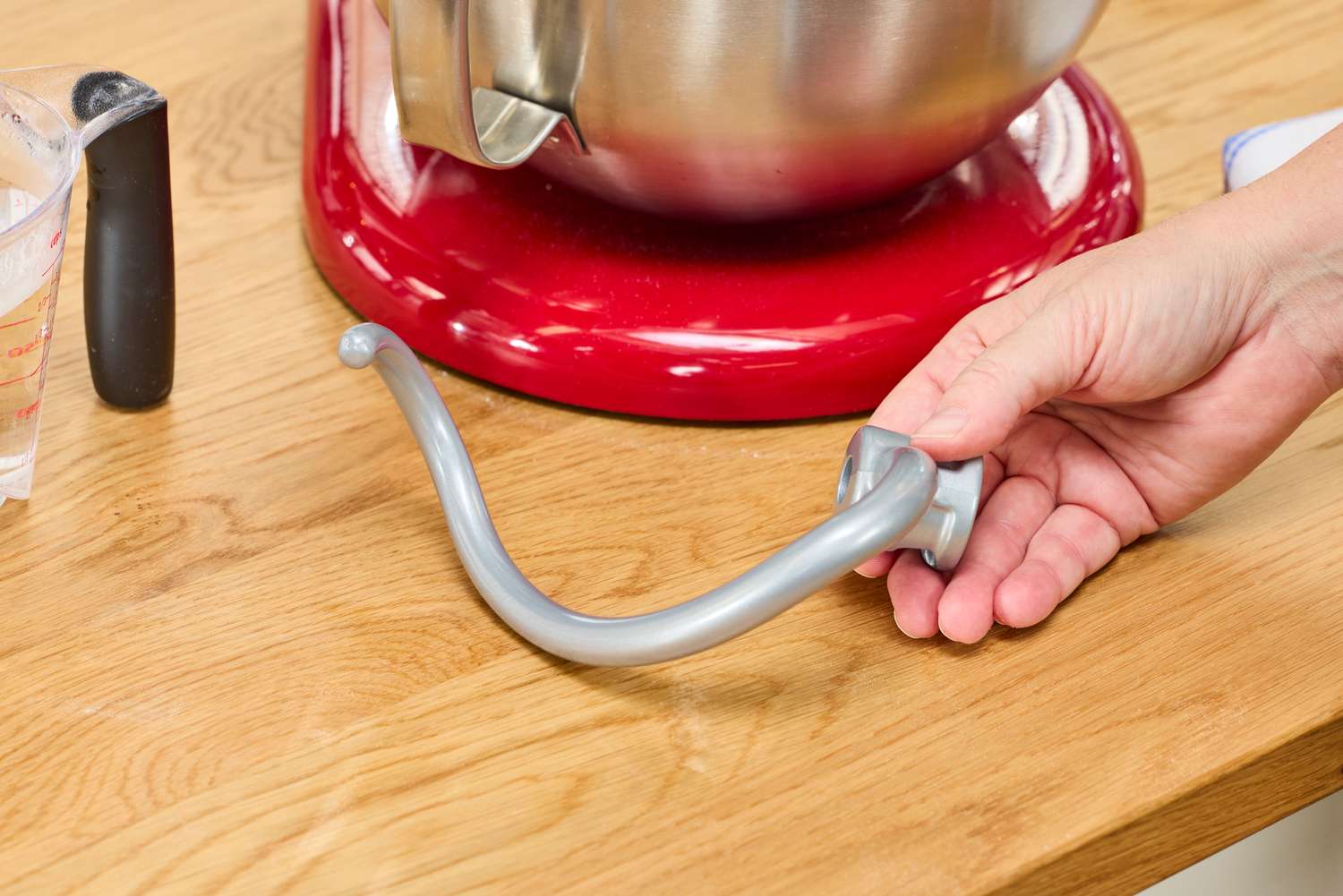 Tester showing dough hook next to KitchenAid stand mixer