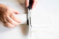 Person sharpening a knife with HORL 3 Cruise Knife Sharpener 