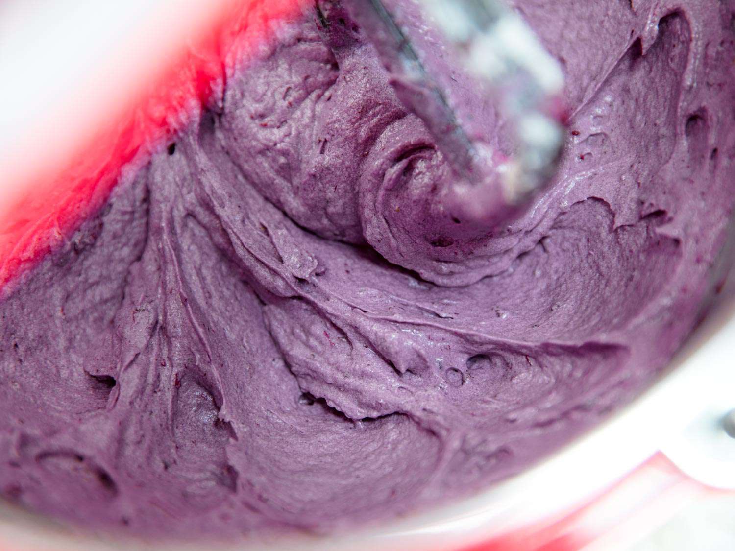 Blackberry cake batter in the bowl of a stand mixer