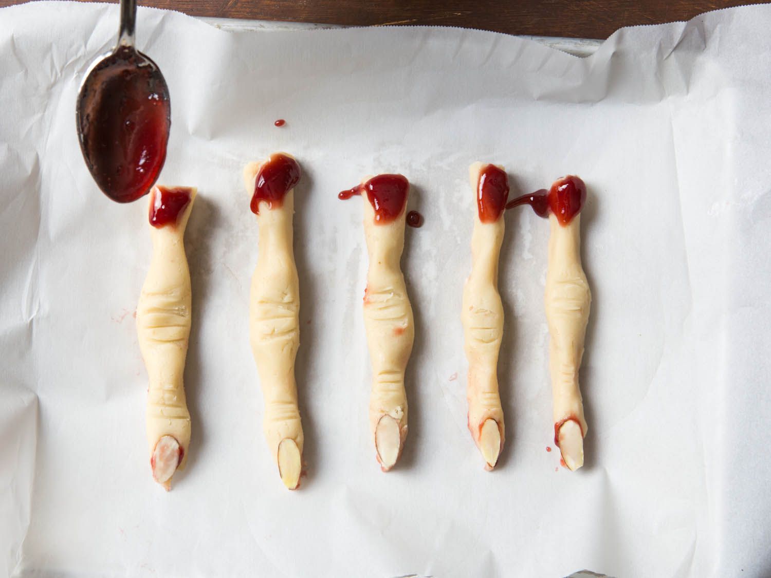 Adding finishing touch to with finger shortbread cookies.
