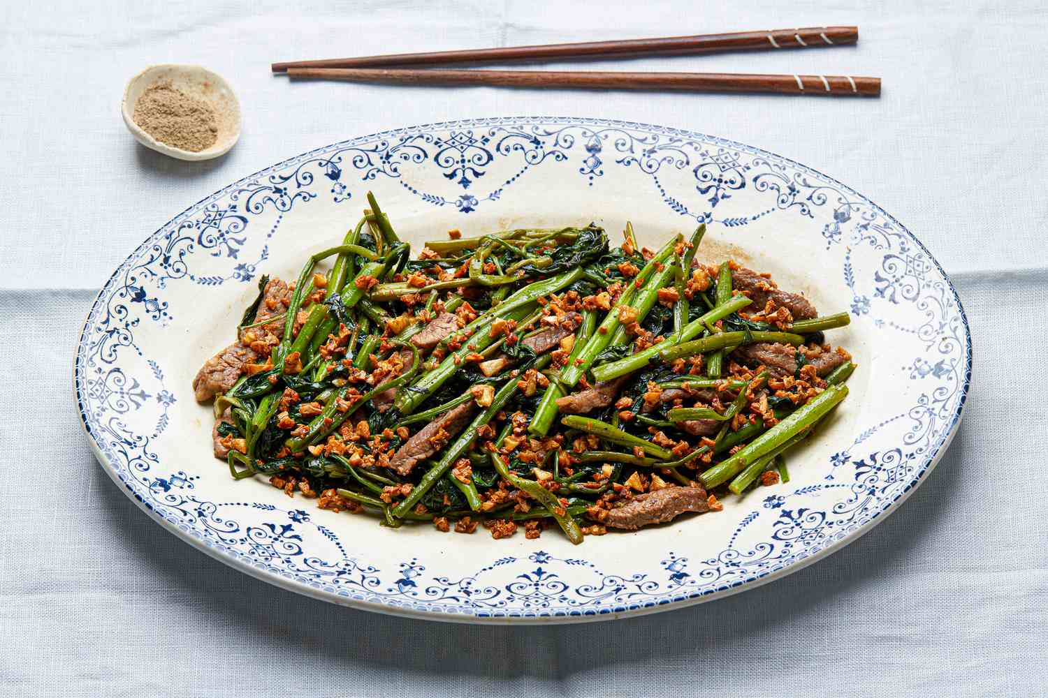 Side view of finished sauteed morning glory with beef