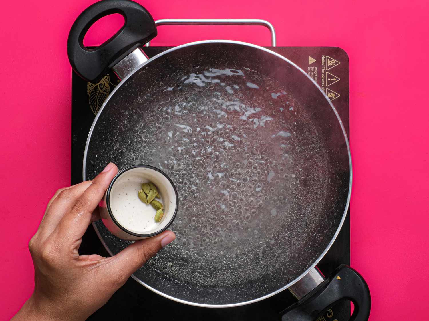 Overhead view of adding cardamon pods