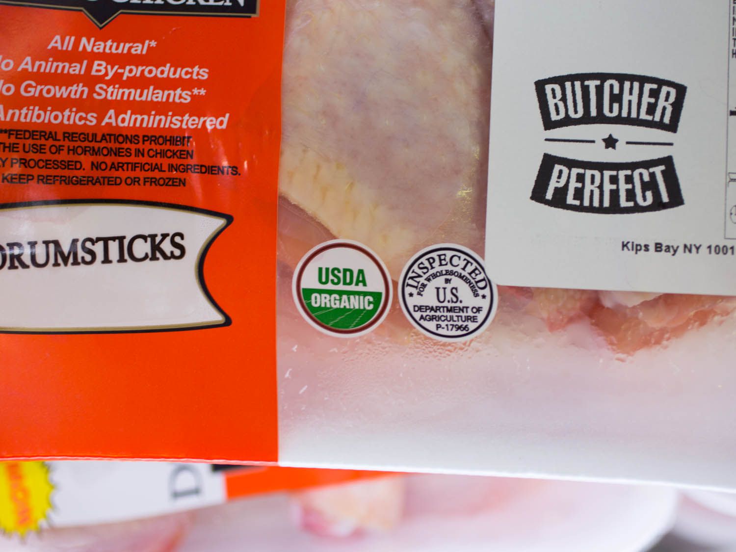 A close up of the USDA Organic seal and the Inspection seal on a package of chicken.
