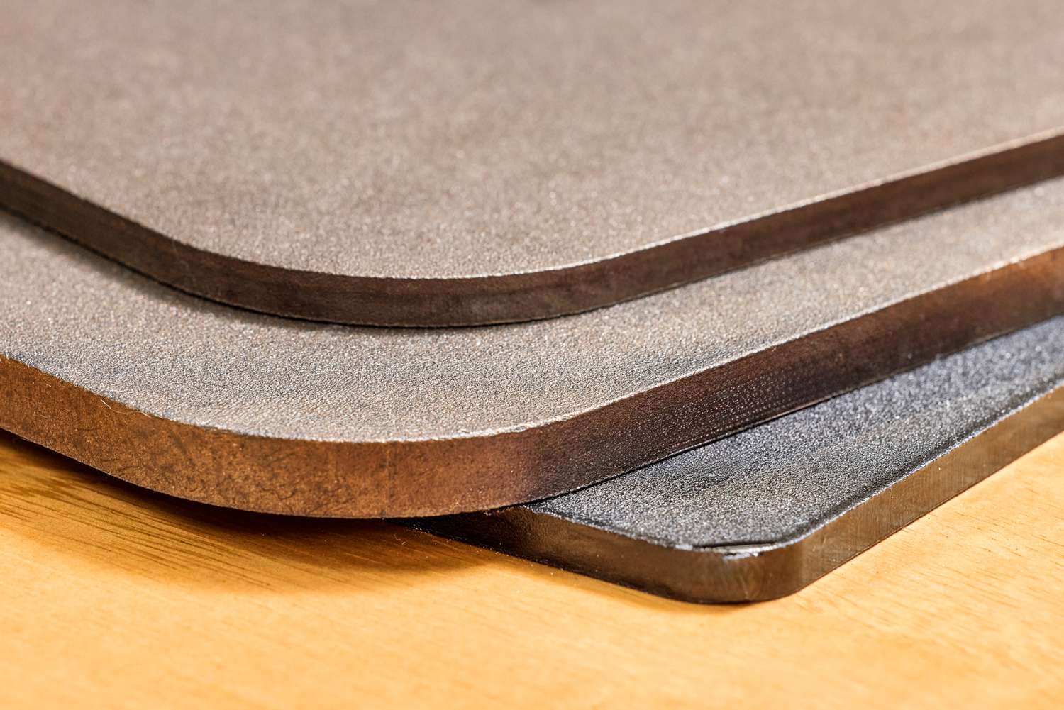 Three pizza steels stacked on top of each other.