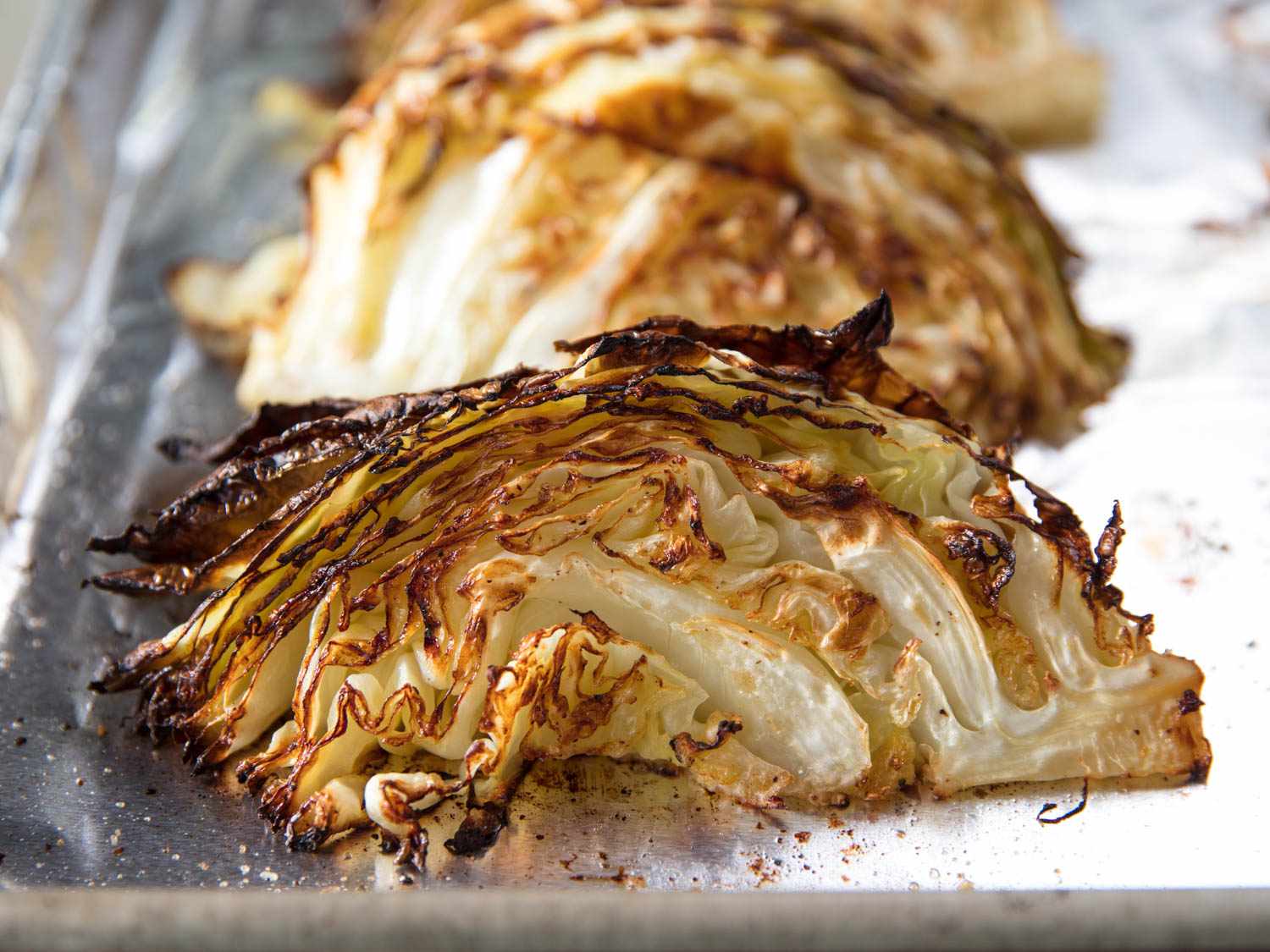 Front view of golden charred cabbage wedges.