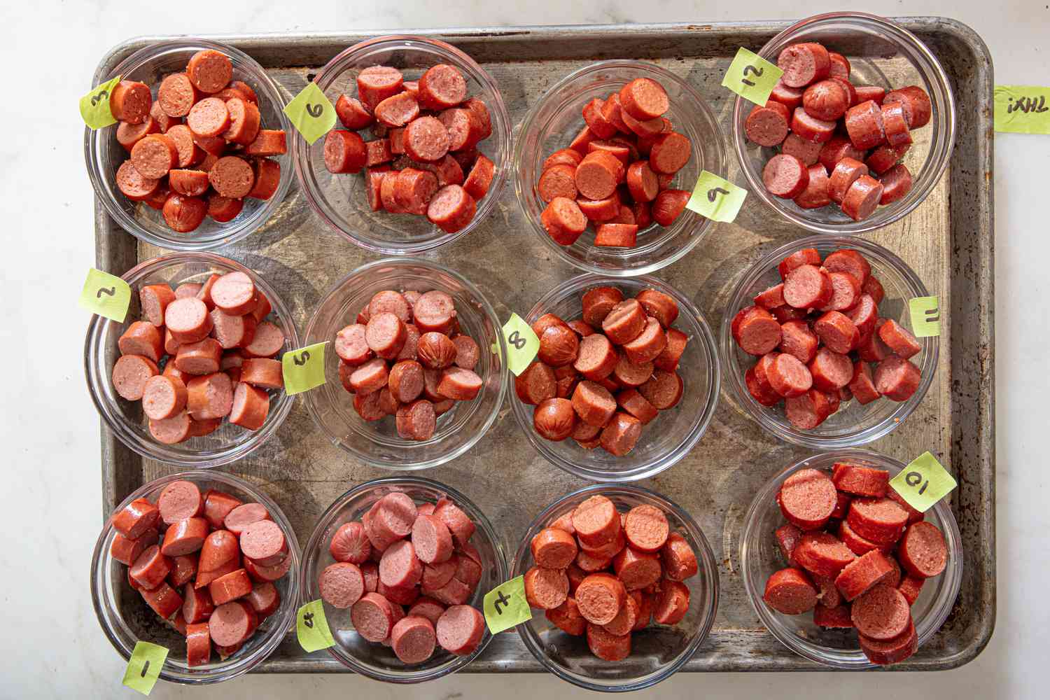 Small bowls of hot dog slices labeled with numbers