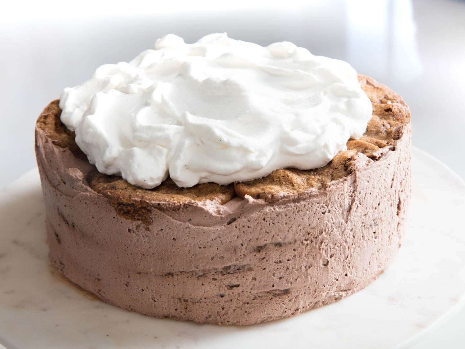 Icebox cake topped with fluffy mounds of whipped cream