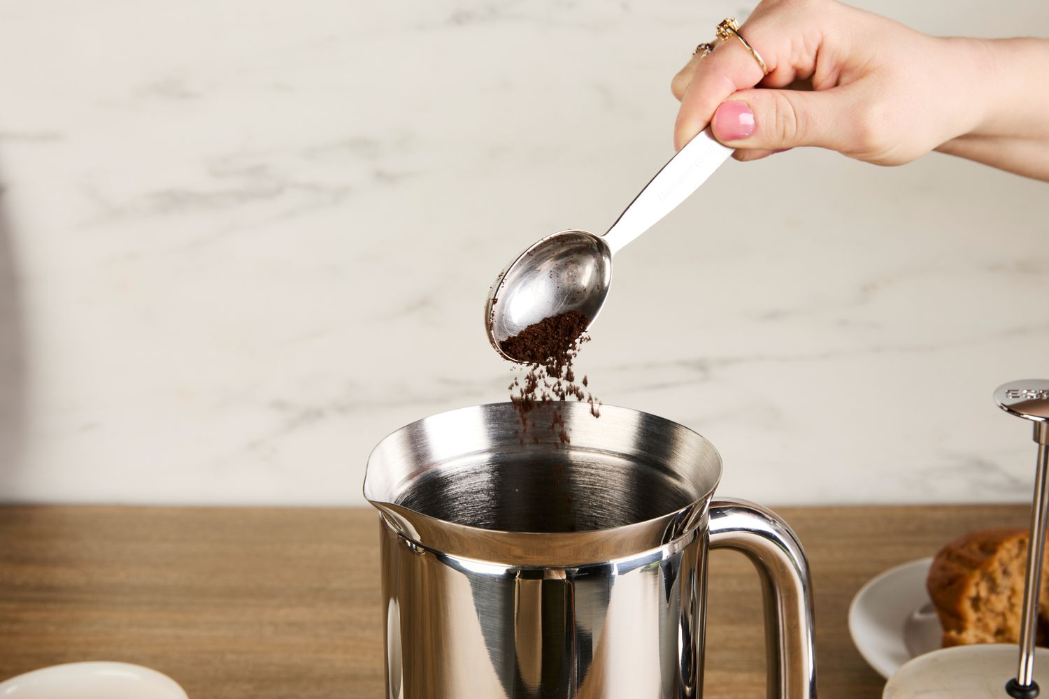 Person pouring coffee grounds into Espro P7 French Press