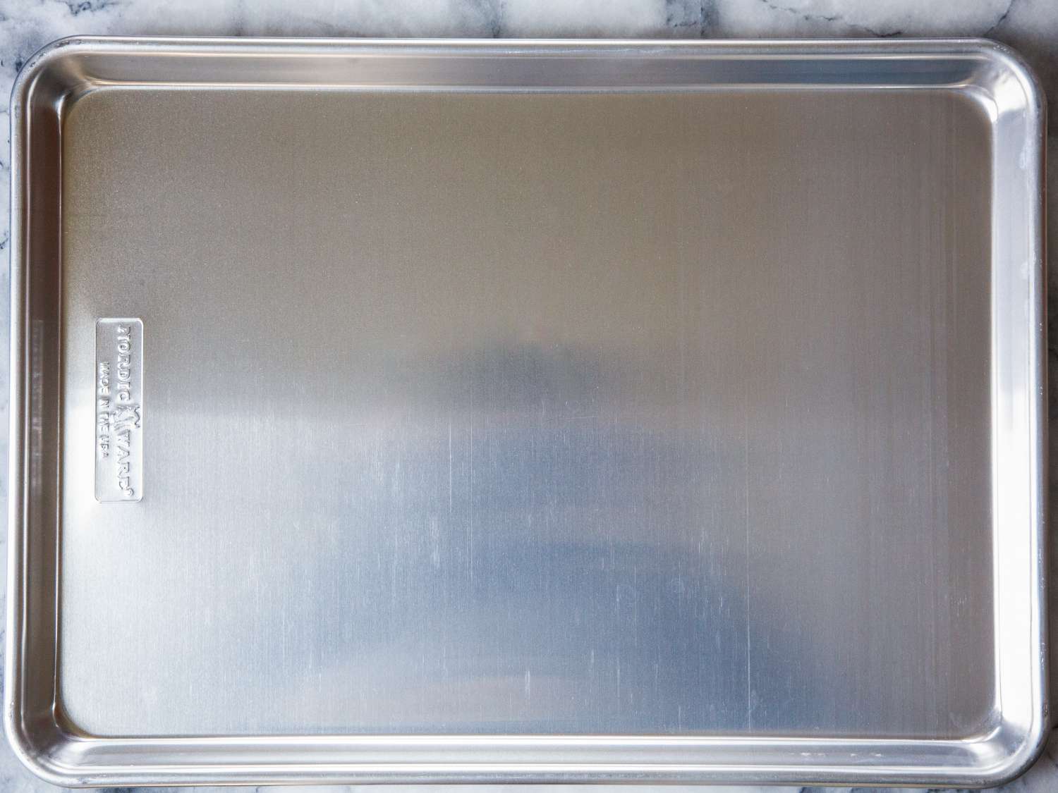 Nordic Ware Naturals Baker's Half Sheet displayed on a marble counter