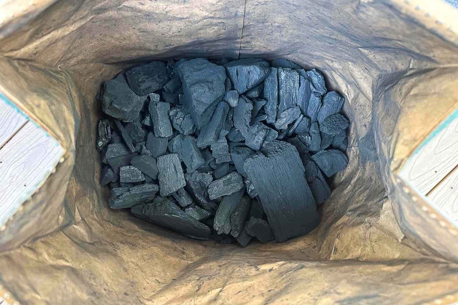 Bag filled with chunks of charcoal viewed from above
