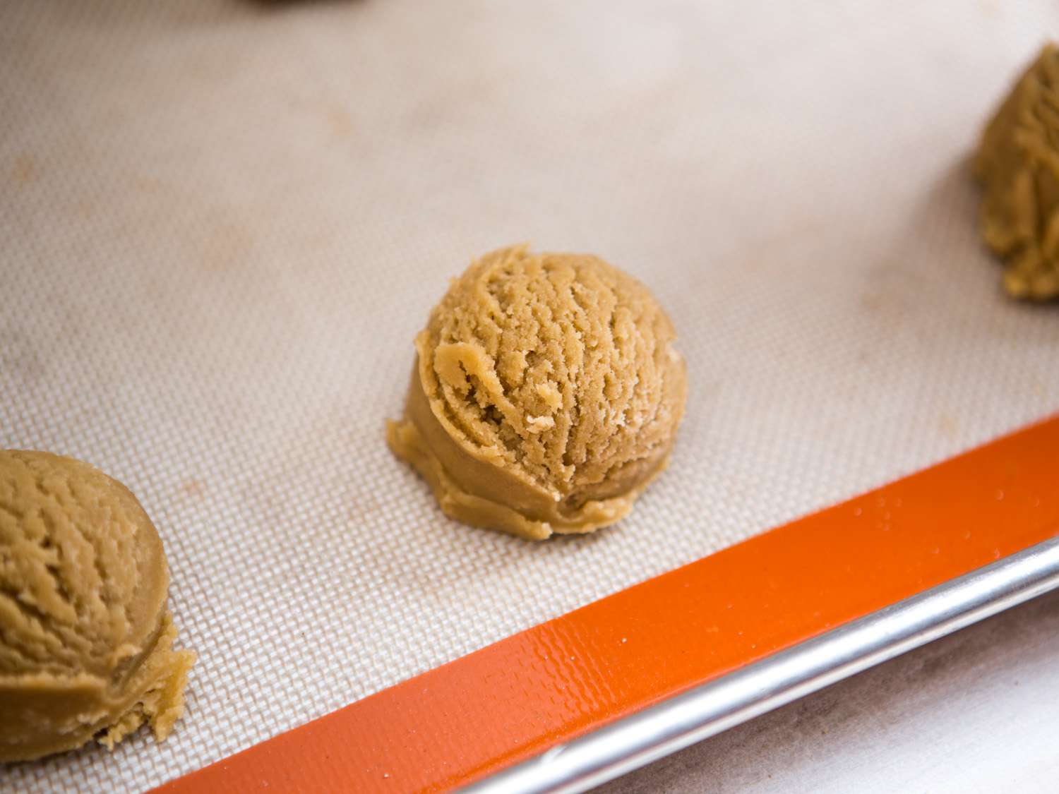 Brown sugar cookie dough resting on a baking sheet