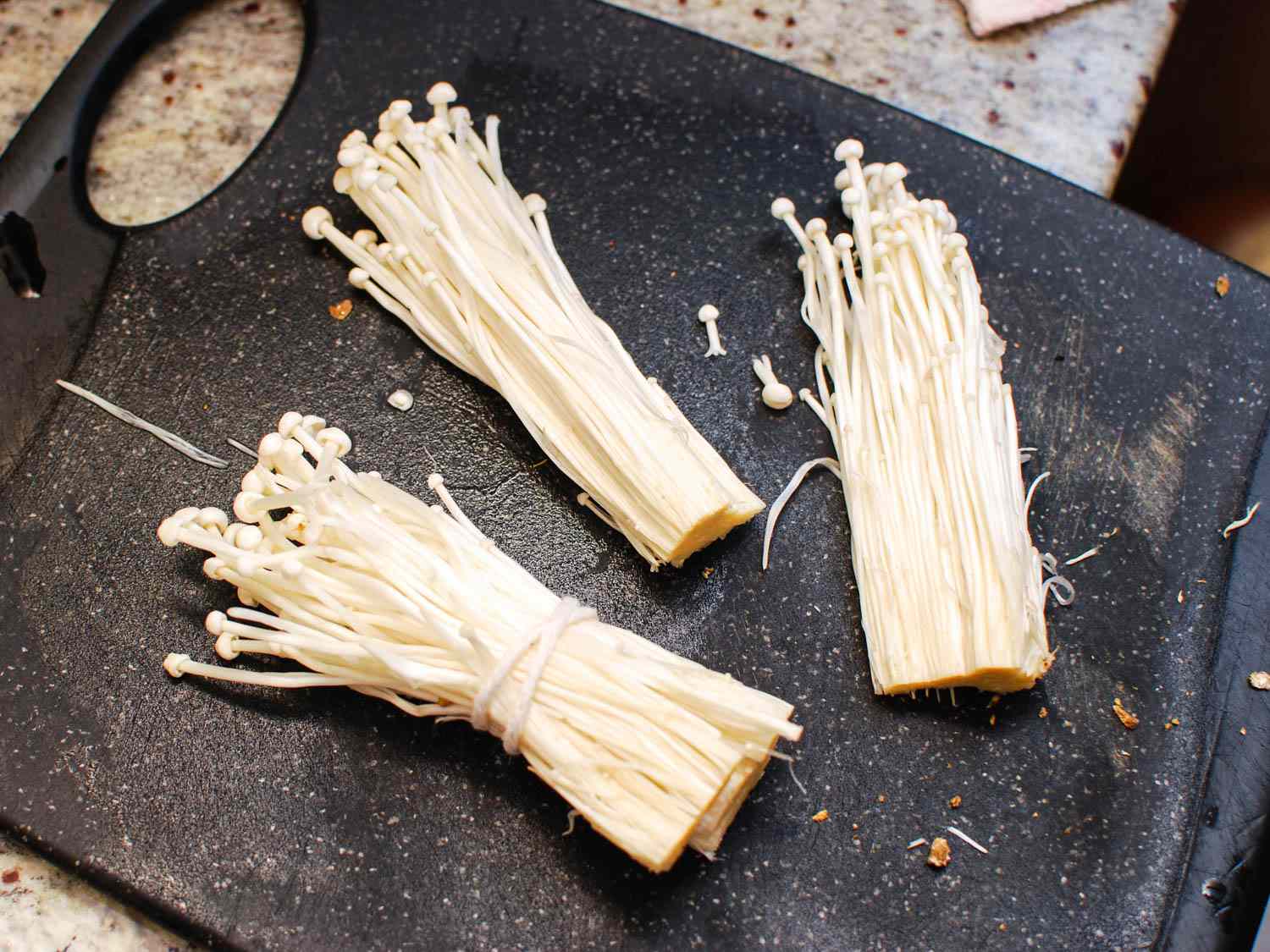 Enoki mushrooms bundled and prepped for grilling.