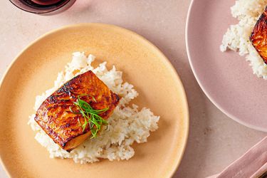 Miso glazed salmon served over white rice on a plate