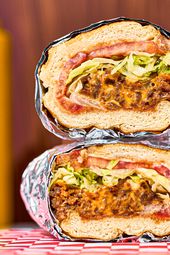 Chopped cheese sandwich stacked on top of one another.