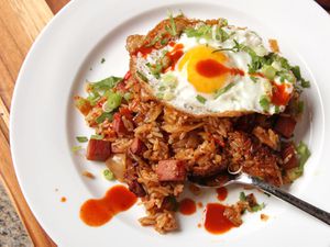 A plate of spam-fried rice topped with a fried egg