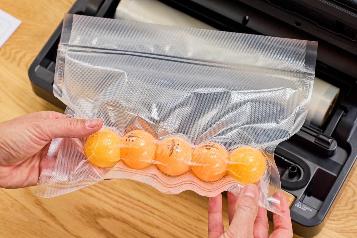 The Anova Precision Vacuum Sealer Pro is used to seal ping pong balls