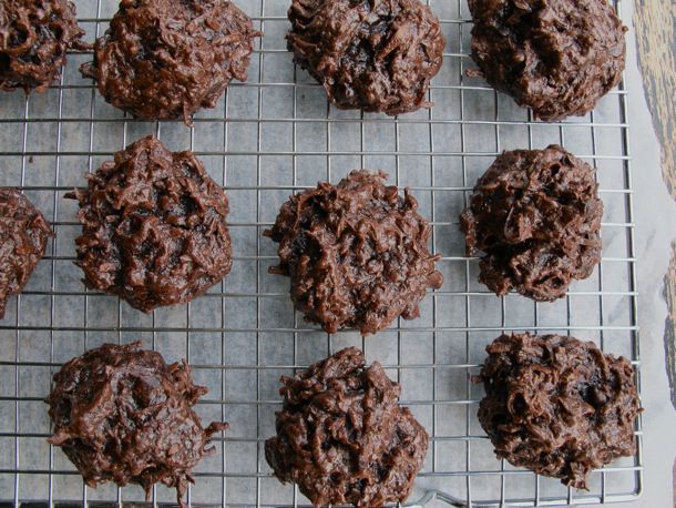 An overhead close-up of double chocolate coconut macaroons cooling on a wire rack.
