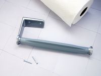 the oxo mounted towel holder with screws and a paper towel on a white tile surface