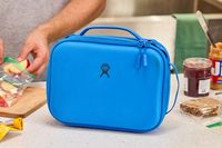 A blue lunch box on a countertop