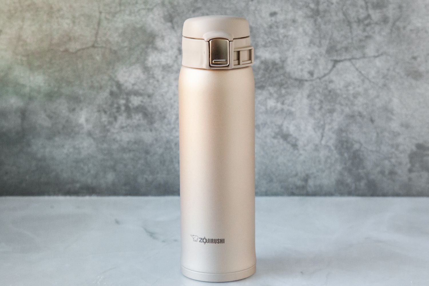 The Zojirushi travel mug on a marble kitchen countertop.