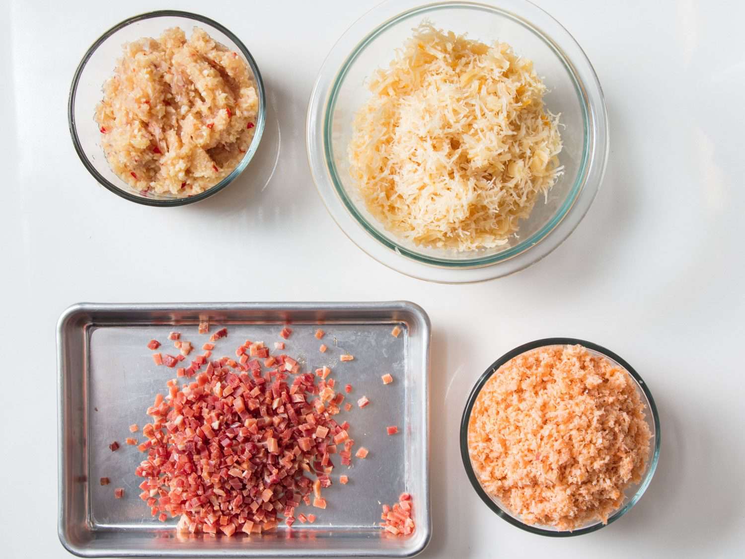 Processed aromatics, scallops, shrimp, and diced ham in separate bowls for XO sauce.
