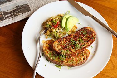 Savory cheese-crusted French toast, served on a white plate.
