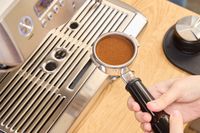 Espresso beans are loaded into the Breville BES920XL Dual Boiler Espresso Machine