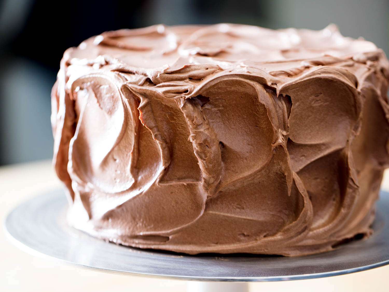 A cake frosted with chocolate Swiss buttercream frosting. 