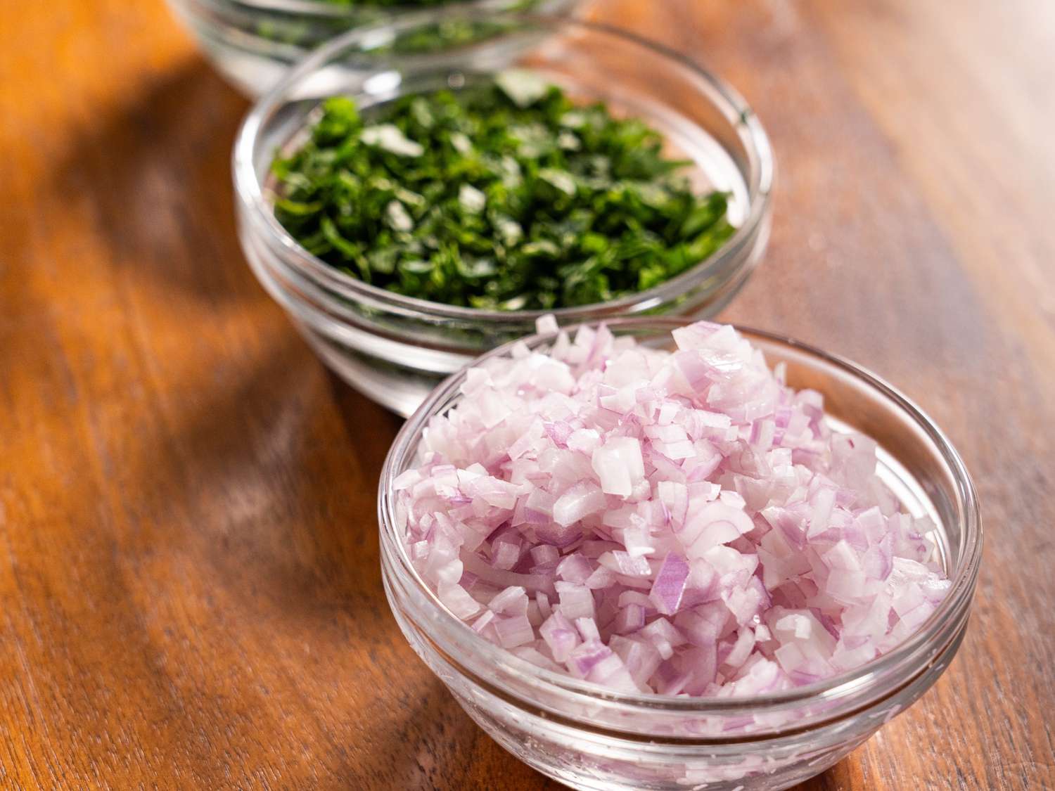 small bowls of diced onions and greens 