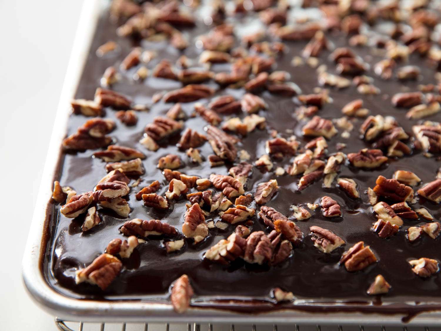 Closeup of the finished Texas sheet cake, studded with pecans and ready to serve.