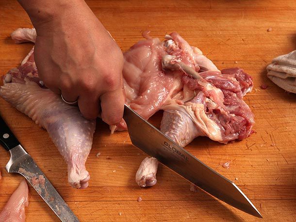 Cracking the leg bone at the ankle with a heavy knife