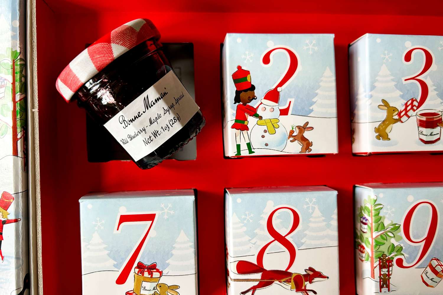 Advent calendar with a jar of Bonne Maman jam under one of the doors