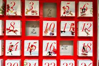The Bonne Maman Advent calendar with some days already opened, revealing festive sayings inside.