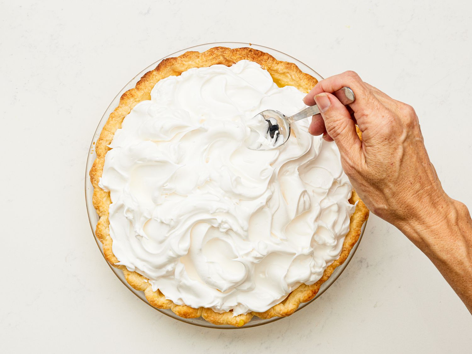 Making peaks in meringue with the back of a spoon