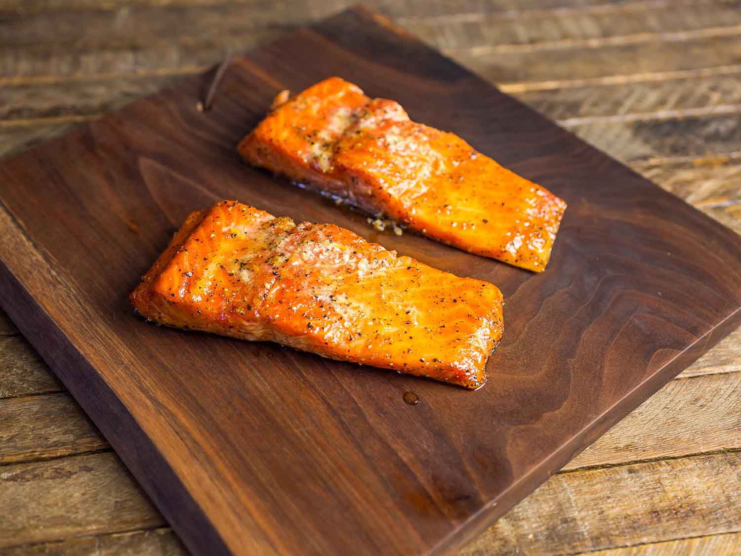 Hot-smoked fish fillet portions on a cutting board, ready to flake.